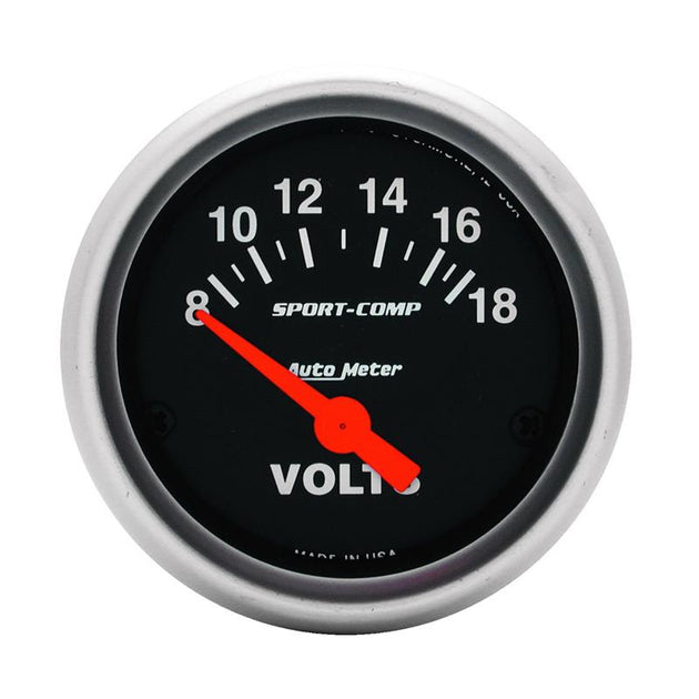 AutoMeter Sport-Comp 52mm electronic voltmeter gauge displaying voltage levels in a car dashboard setting.