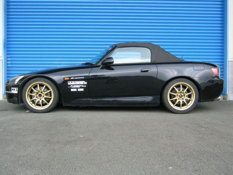 HKS HIPERMAX S AP1 coilover kit with adjustable shock absorbers and springs for enhanced suspension performance on a sports car.