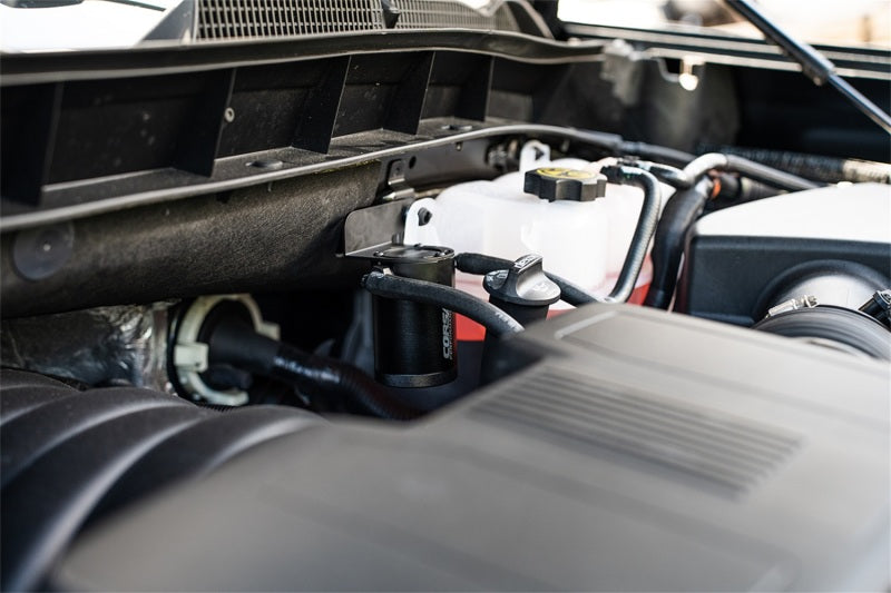CORSA Performance aluminum oil catch can installed in a Silverado/Sierra or Tahoe/Suburban/Yukon vehicle engine bay.