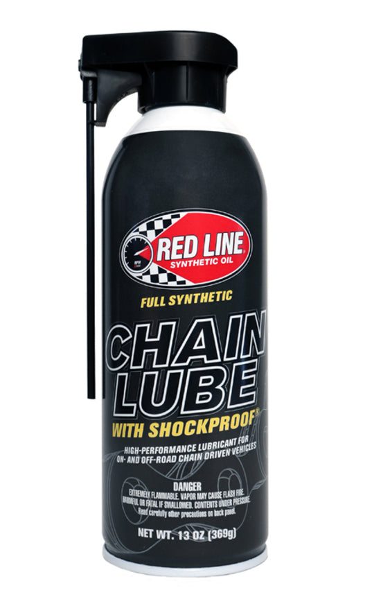 Red Line Chain Lube aerosol can, 13oz, for bike chains and lubricants, with red and black packaging and product label visible.