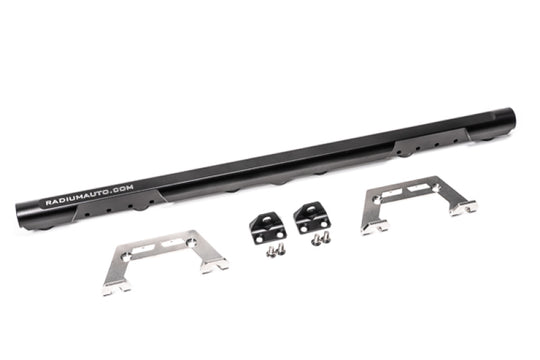 Radium Engineering BMW M50 M52 M54 S50 S52 fuel rail with polished metal finish, mounted on engine with fuel fittings and injection ports.