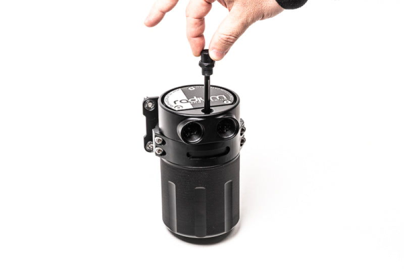 Radium Engineering Competition Catch Can L for oil catch cans, showing the sleek black metal container with hoses attached.
