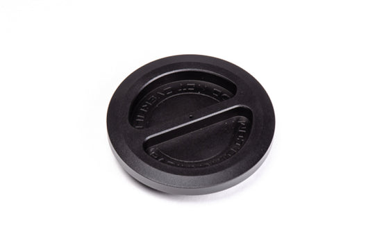 Radium Engineering remote mount vented fuel cap on fuel lines, showing durable metal construction and secure mounting details.