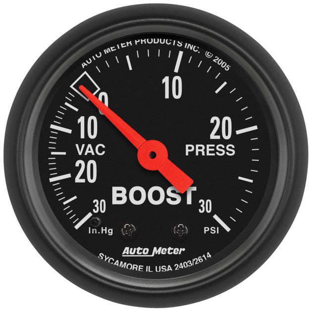 AutoMeter Z Series 52mm vacuum and boost gauge showing 30 in Hg. vacuum and 30 PSI boost readings, with clear dial markings.