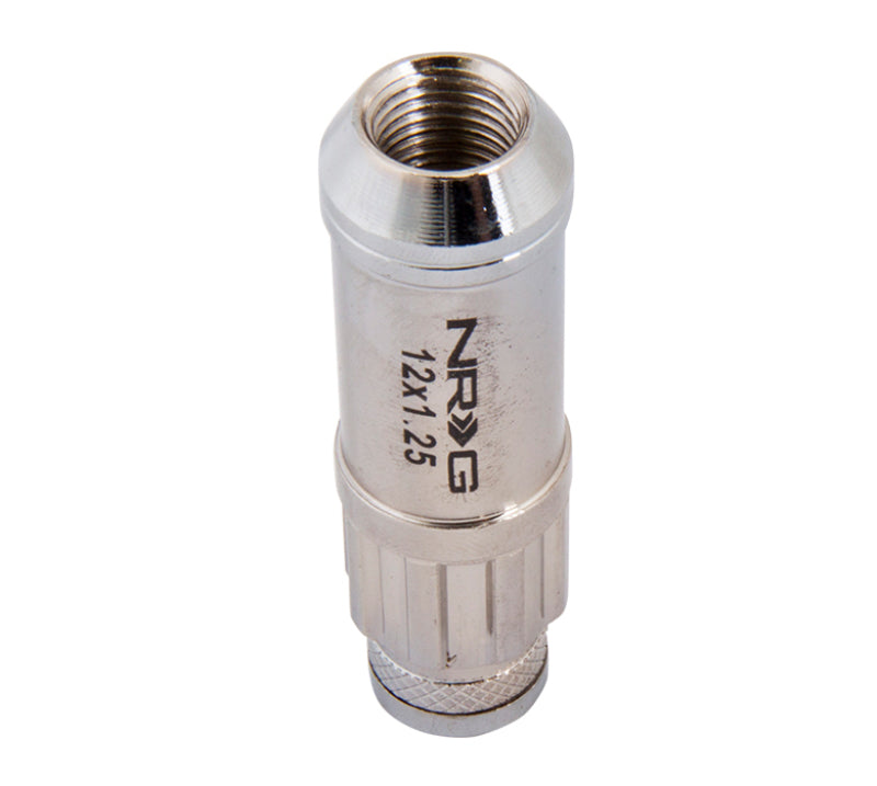 NRG 700 Series M12 x 1.25 steel lug nuts with dust cap cover set, locks, and lock socket in silver, shown on a wheel.