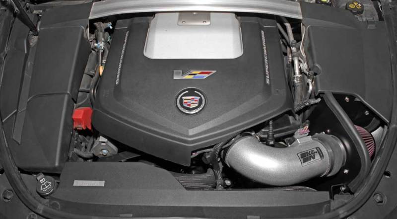 K&N Engineering cold air intake for 2009-2015 Cadillac STS-V 6.2L V8 engine, featuring the Typhoon performance air filter and intake tube.