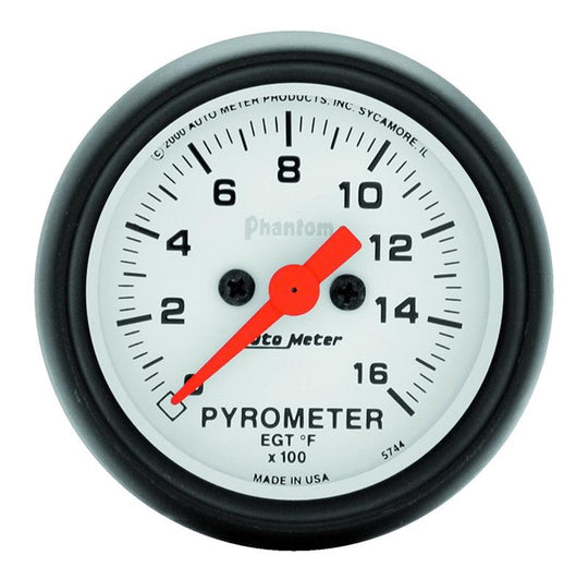 AutoMeter Phantom 52mm electronic EGT gauge kit displaying a digital temperature readout in a car dashboard setting.