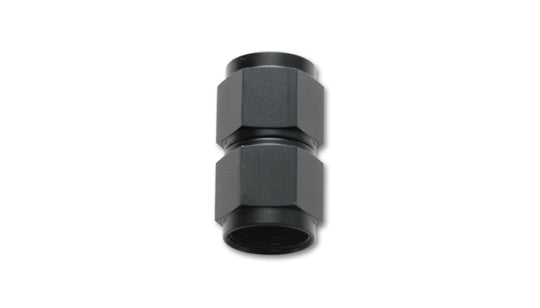 Vibrant black anodized aluminum straight coupler union adapter, -10 AN to -12 AN female fittings for automotive or racing applications.
