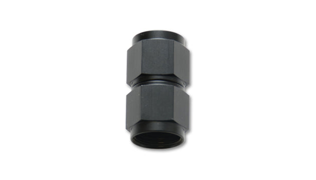 Vibrant black anodized aluminum straight coupler union adapter, -10 AN to -12 AN female fittings for automotive or racing applications.