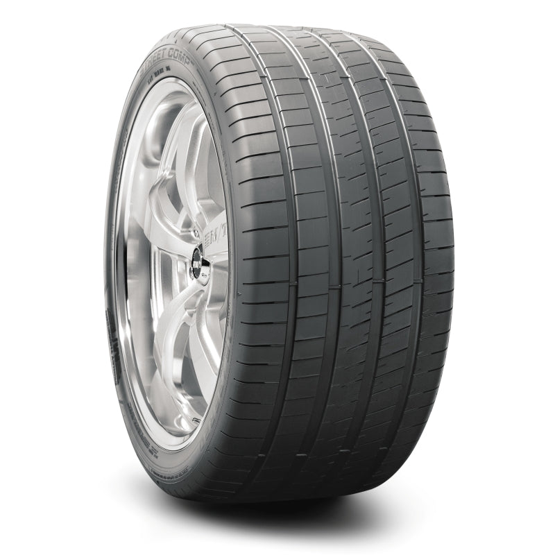 Mickey Thompson Street Comp GHT 285/30R19 98Y XL UTV tire shown on road with tread pattern and sidewall branding.
