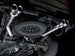 AWE Tuning 4th Gen GM 1500 6.2L catback exhaust with quad chrome tips and split rear exit, featuring bumper cutouts.