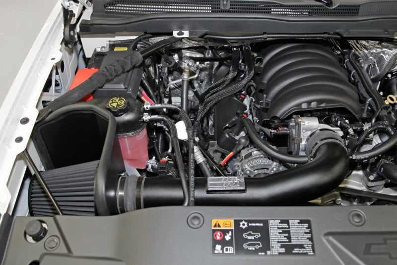 K&N 71 Series cold air intake kit installed in a Chevrolet Silverado or GMC Sierra 2014-2015, showcasing the performance air filter and intake tube.