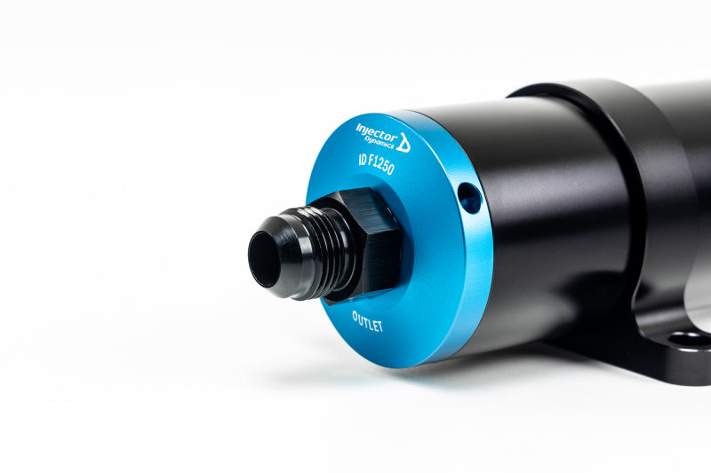 Injector Dynamics ID-F1250 fuel filter for high-performance vehicles, showing the compact, durable metal design and filtration element.