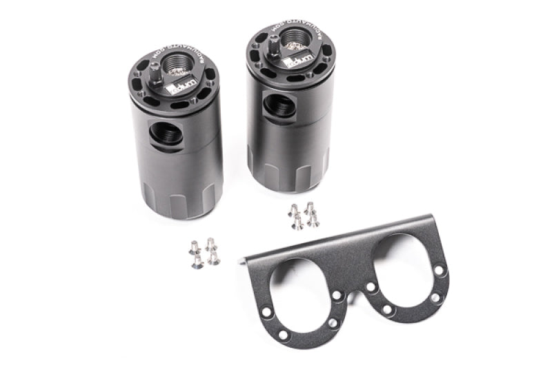 Radium Engineering dual universal oil catch can kit with fluid lock, mounted on engine bay, black aluminum cans for vehicle emission control