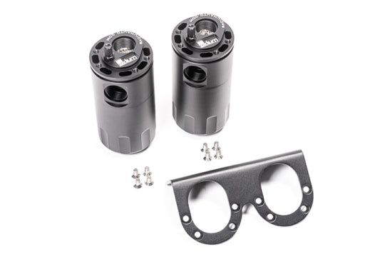 Radium Engineering dual universal oil catch can kit with fluid lock, mounted on engine bay, black aluminum cans for vehicle emission control