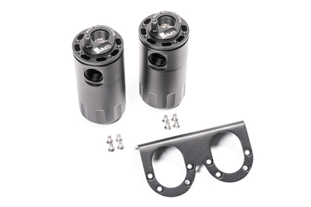 Radium Engineering dual universal oil catch can kit with fluid lock, mounted on engine bay, black aluminum cans for vehicle emission control