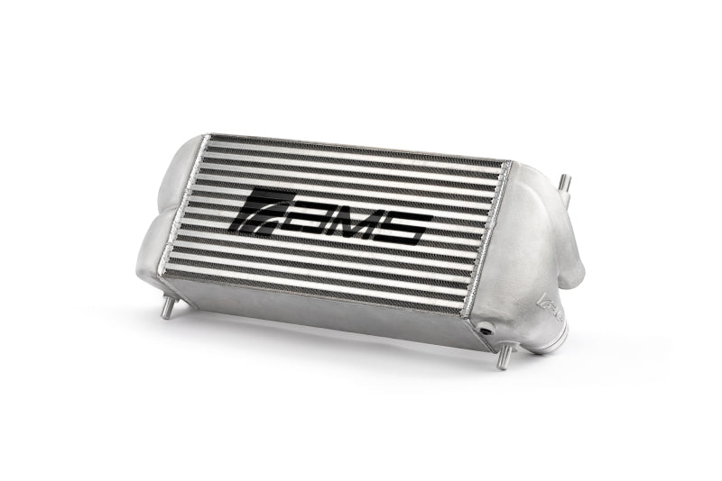 Silver AMS Performance intercooler for 2015+ Ford F-150 Raptor 2.7L/3.5L EcoBoost with logo, showing fins and mounting edges.