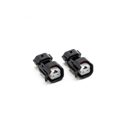 DeatschWerks USCAR to Denso (Sumitomo) PnP fuel injector connector adapter, showing the black plastic and metal contact points.
