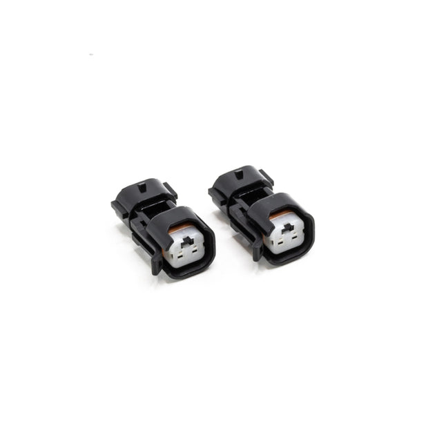 DeatschWerks USCAR to Denso (Sumitomo) PnP fuel injector connector adapter, showing the black plastic and metal contact points.