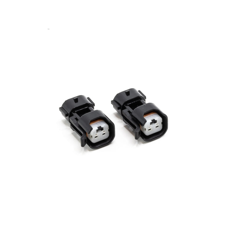 DeatschWerks USCAR to Denso (Sumitomo) PnP fuel injector connector adapter, showing the black plastic and metal contact points.