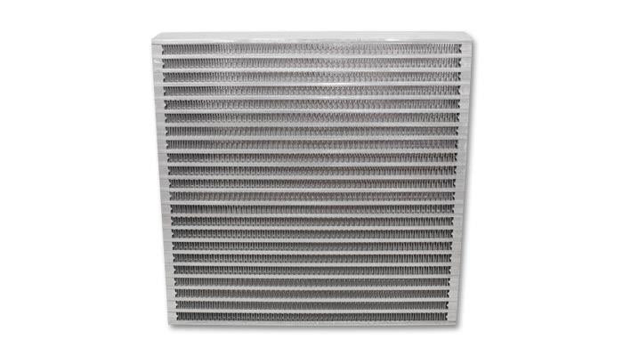 Vibrant universal oil cooler core, 12x12x2 inches, with metal fins and inlet/outlet fittings, designed for automotive oil cooling systems.