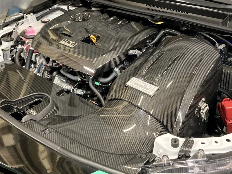 HKS Cold Air Intake Full Kit GZEA14H for improved engine airflow, shown installed on a vehicle with visible intake components.