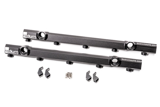Radium Engineering fuel rails installed in an Audi R8 and Lamborghini Huracan, showcasing polished metal components.