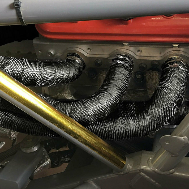 Black DEI Exhaust Wrap 2in x 100ft Titanium heat-resistant wrap for exhaust pipes, shown coiled and ready for installation.