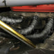 Black DEI Exhaust Wrap 2in x 100ft Titanium heat-resistant wrap for exhaust pipes, shown coiled and ready for installation.