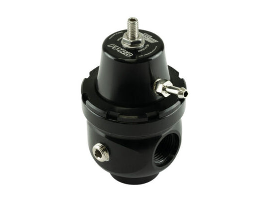Turbosmart FPR8 fuel pressure regulator installed in a vehicle engine, showcasing its compact design and connection fittings.