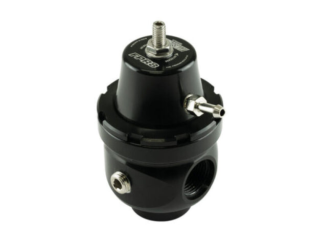 Turbosmart FPR8 fuel pressure regulator installed in a vehicle engine, showcasing its compact design and connection fittings.