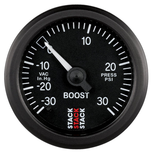 AutoMeter 52mm black mechanical boost gauge showing pressure from -30 inHg to +30 psi for automotive engine monitoring.