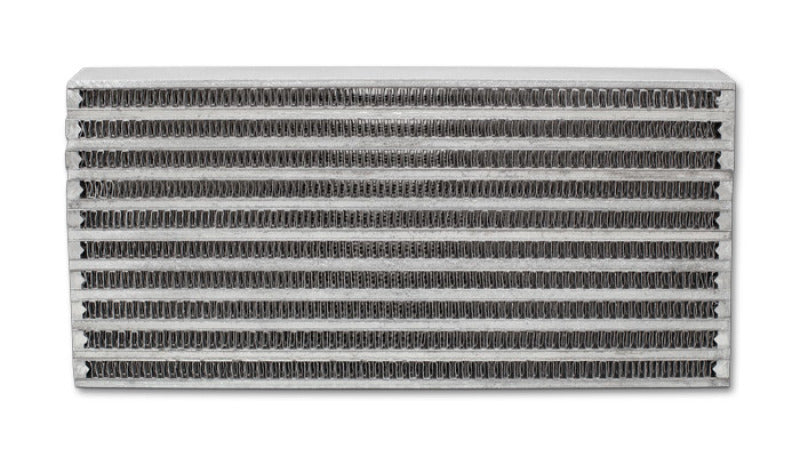 Vibrant universal oil cooler core, 6x10x2 inches, with metal fins and inlet/outlet ports for automotive oil cooling system.