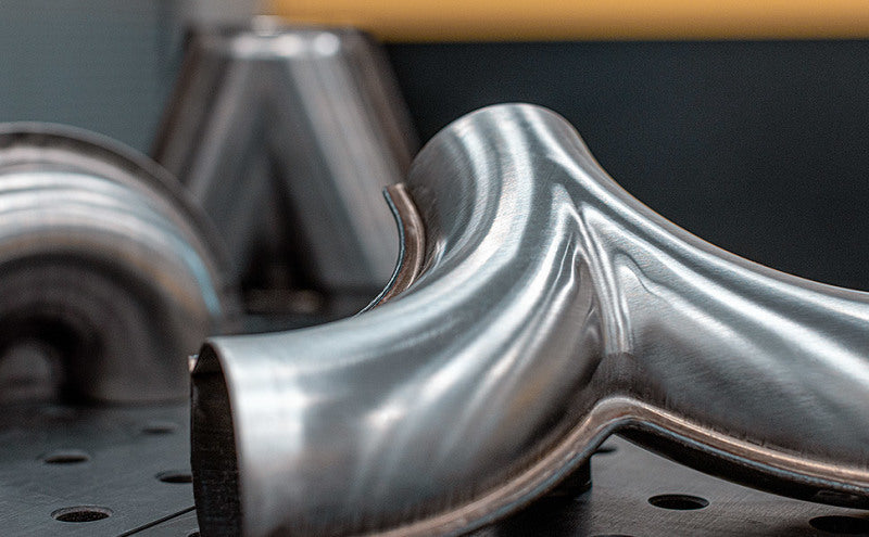 MagnaFlow Y pipe, 2.5/3 inch diameter, aluminum finish, smooth transition design, suitable for exhaust systems.