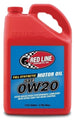 Red Line 0W20 motor oil gallon container with red and white labeling, suitable for engine lubrication and maintenance.