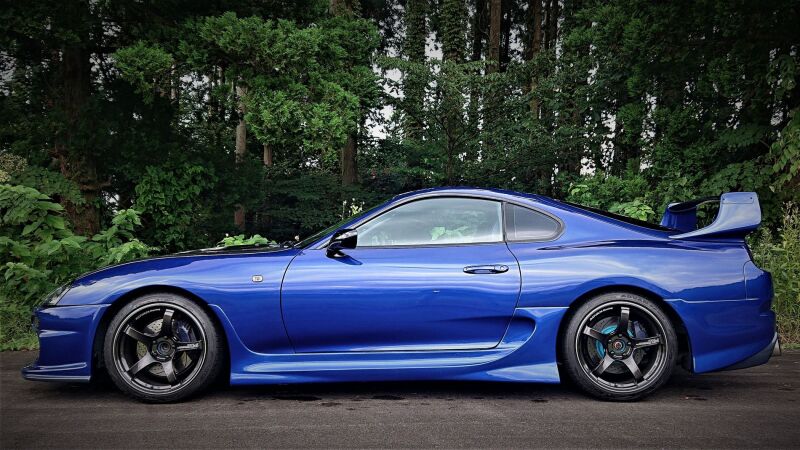 HKS Hipermax S coilover kit installed on a Toyota Supra JZA80, showing the adjustable shock absorbers and suspension components.