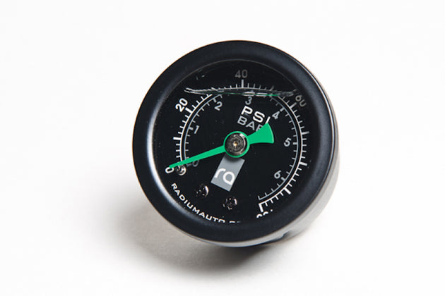 Radium Engineering 0-100 PSI fuel pressure gauge showing a clear dial and needle indicating pressure levels in a vehicle engine system.