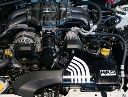 HKS Subaru ZN8/ZD8 cold air intake full kit showing the black metal intake pipes and air filters.