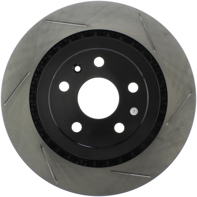 Rear left StopTech Sport slotted brake rotor showing perforated metal surface with slotted design for improved cooling and braking performance.