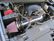 K&N Engineering high flow cold air intake kit installed in a 2009-2010 Yukon, Sierra, Tahoe, Silverado, or Escalade for improved performance.